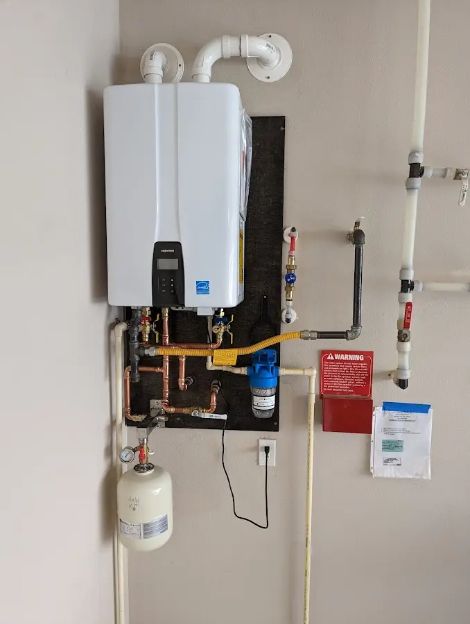 Professional plumber installing copper piping in a Oak Harbor home